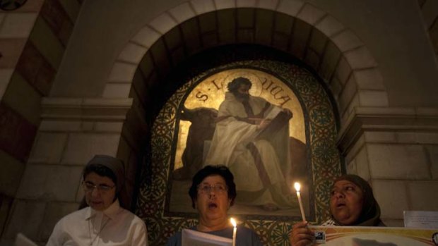 Palestinian Christians and Muslims take part in a service in Jerusalem.