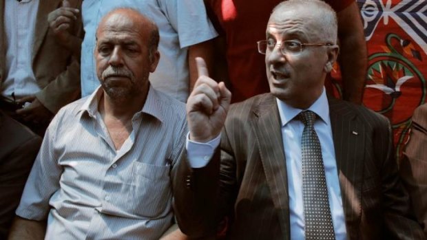 Mohammed's father, Hussein Abu Khadeir, left, with Palestinian Prime Minister Rami Hamdallah.