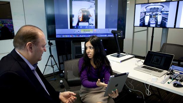 William Ruh, left, who runs General Electric's new software center in San Ramon, California, talks to employee, Sharoda Paul, an expert in social computing, at the company's centre in San Ramon.