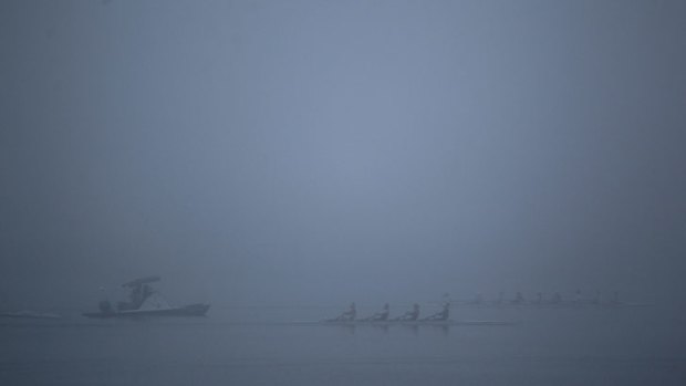 Rowers train on the waters of Iron Cove in Haberfield, surrounded in fog.