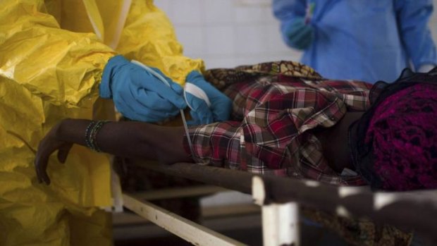 Medical staff treat a suspected ebola patient in Kenema, Sierra Leone.