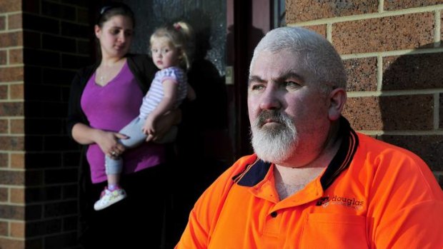 Michael Richer sits outside his house in Latham with his daughter Kylie RIcher and granddaughter Sarah Watson. On Monday he lost his job at Douglas Quality Joinery.