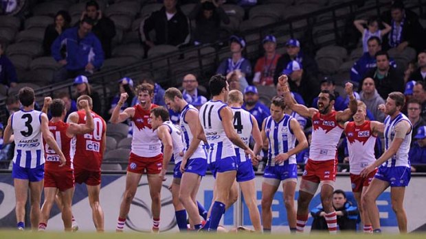 Close one: Sydney players celebrate their one-point win over North Melbourne.