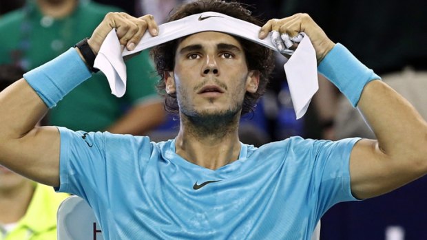 Rafael Nadal adjusts his headband during a break in play.