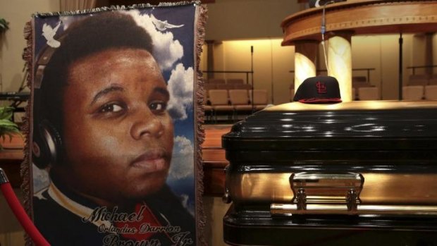 A baseball cap and a portrait of Michael Brown is shown alongside his casket inside Friendly Temple Missionary Baptist Church before the start of his funeral service in St Louis, Missouri.