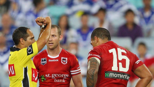 Referee Matt Cecchin places Leeson Ah Mau of the Dragons on report.