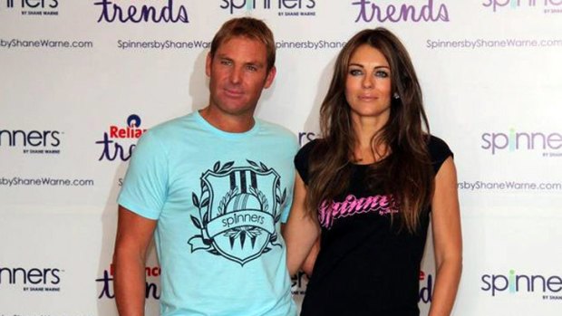 Glowing ... Shane Warne and Liz Hurley pose in a promotional shoot for the Shane Warne Foundation charity auction last month.