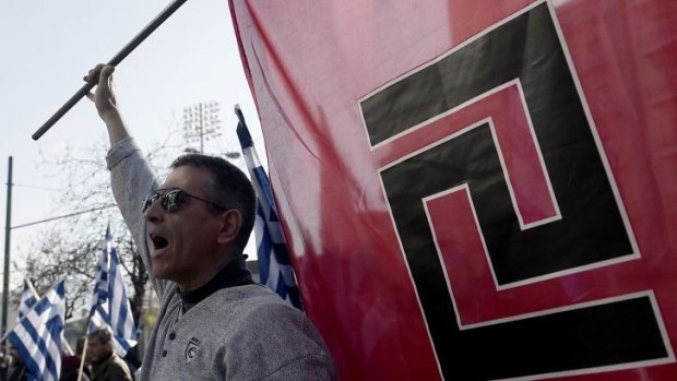Supporters of ultra-nationalist party Golden Dawn shout slogans outside a courthouse in Athens.