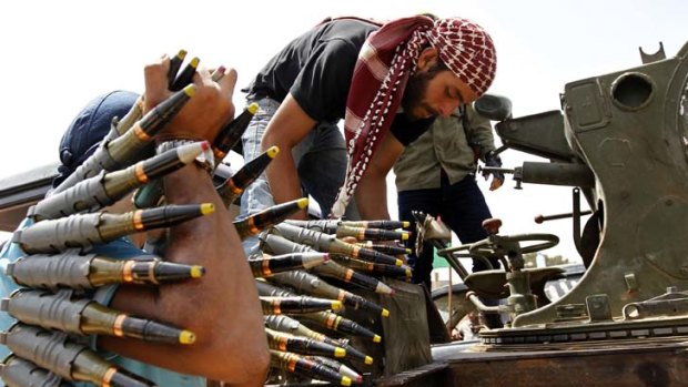 Stalemate ... Libyan rebel fighters prepare their heavy machinefun at Misrata's western front line on Monday.