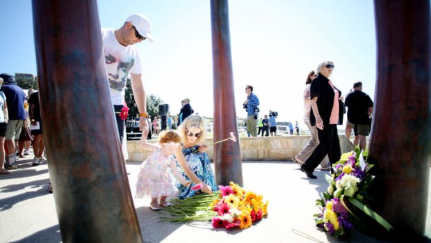 Mourners lay flowers at the Coogee memorial for those who lost their lives in the Bali nightclub bombings.