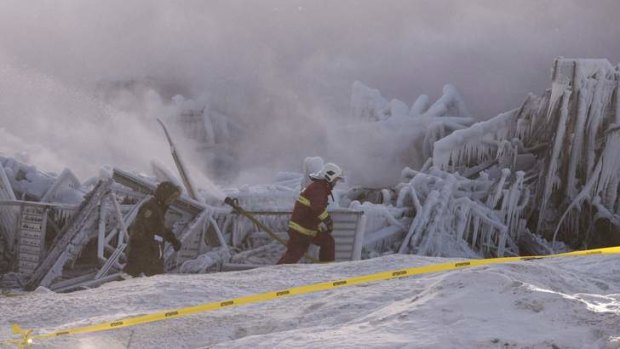 Firefighters work at the scene of a nursing home fire in L'Isle-Verte, Quebec.
