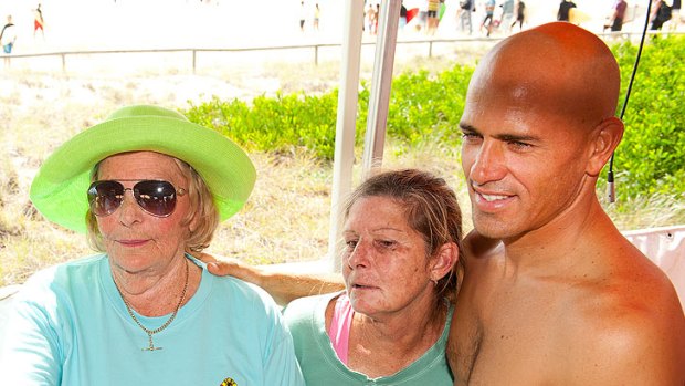 Michael Petersons mother Joan Watt (left) Kelly Slater (right) pose for a picture at the Michael Peterson memorial held at Kirra Beach Coolangatta.