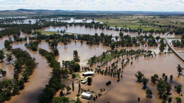 Waste deep &#8230; floodwaters swirl around Wagga Wagga, where farmers are using tinnies to rescue stranded sheep.