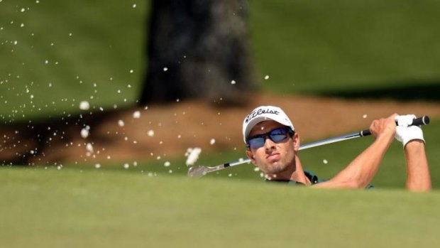 Adam Scott plays a shot during the first round of the 78th Masters Golf Tournament at Augusta National Golf Club. 