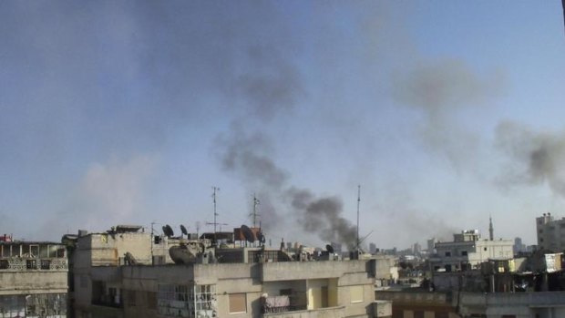 Smoke rising from the Al Qusoor district of Homs.