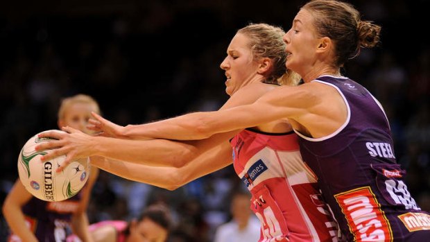 Erin Bell of the Thunderbirds contests for the ball with Amy Steel of the Firebirds in an earlier clash