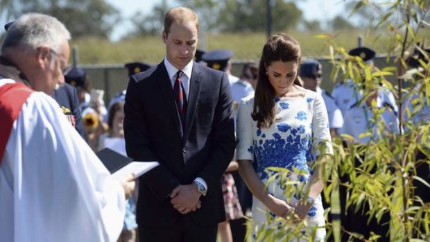 Britain's Prince William and Catherine, Duchess of Cambridge bow their heads in prayer after planting a tree at the Memorial Garden during a visit to Royal Australian Air Force (RAAF) Base Amberley near Brisbane.