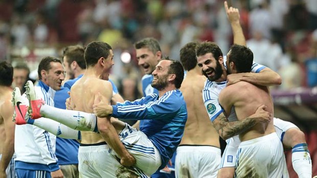 The Greek national side celebrate after beating Russia at the Euro 2012 championships at the National Stadium in Warsaw.