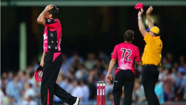 Moises Henriques of the Sixers looks dejected after Alex Hales hits consecutive sixes.