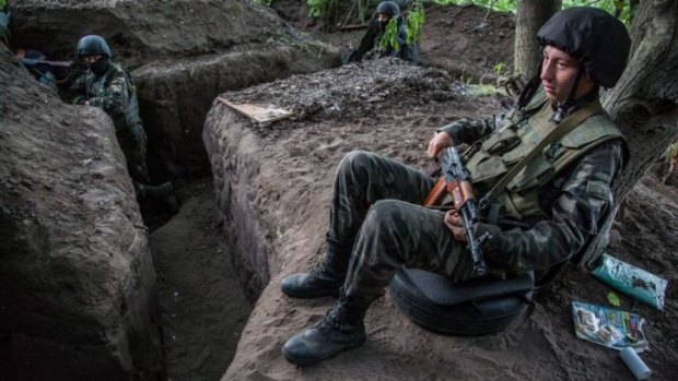 A Ukrainian government soldier rests at his position at a checkpoint near Slovyansk, Ukraine. 11 soldiers are reported to have been killed after a Ukraine army checkpoint was attacked by pro-Russian forces in eastern Donetsk.