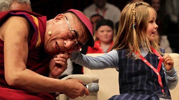 Ticklish spot: The Dalai Lama meets school children at the Young Minds conference at Sydney Town Hall on Monday.