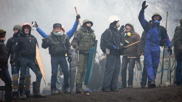 Protesters defy security forces in Kiev on Thursday.