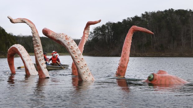 In this Wednesday, March 30, 2016 photo, a giant octopus sculpture named Ivan settles into his new home in Lake Robertson near Lexington, Va. The sculpture was created by Natural Bridge based artist Mark Cline who along with his helpers, Sergio Becerra and Melvin Dudley rowed Ivan to the middle of the lake after putting the creation together at the boat launch to be displayed for April Fools' Day. Every year since 2001 Cline has created an April Fools' display in the state of Virginia. (Heather Rousseau/The Roanoke Times via AP) LOCAL TELEVISION OUT; SALEM TIMES REGISTER OUT; FINCASTLE HERALD OUT;  CHRISTIANBURG NEWS MESSENGER OUT; RADFORD NEWS JOURNAL OUT; ROANOKE STAR SENTINEL OUT; MANDATORY CREDIT