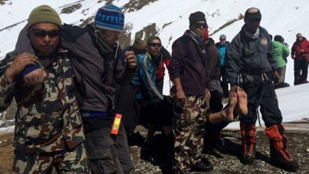 Saved: Nepalese army personnel rescue survivors in the blizzard.