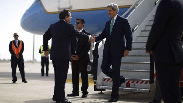 Wherever, whenever: US ambassador Stuart Jones greets John Kerry as he arrives in Amman. Mr Kerry's aides say he is willing to take considerable risks to cement his legacy as a peacemaker.