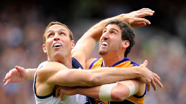 Geelong's Brad Ottens battles with West Coast's Dean Cox in their preliminary final at the MCG.