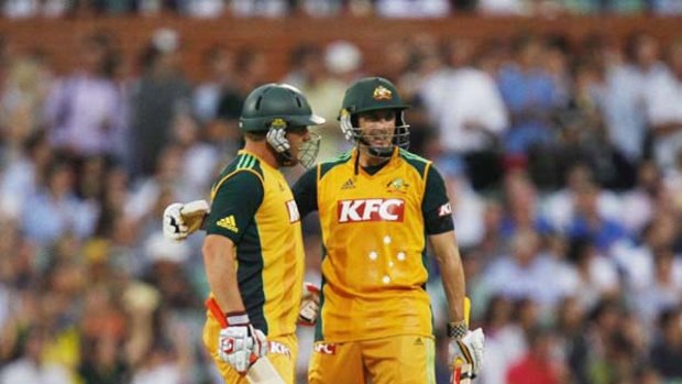Aaron Finch (left) congratulates David Hussey after he hit a boundary during the Twenty-20 game against England on Wednesday..