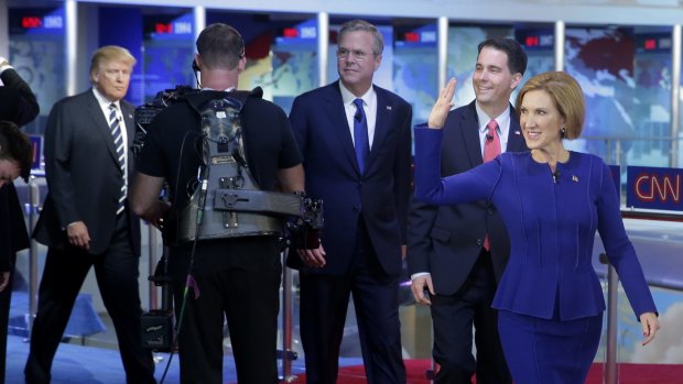 Carly Fiorina, right, leads fellow candidates Scott Walker, Jeb Bush and Donald Trump as they take the stage prior to the CNN Republican presidential debate in Simi Valley, California.