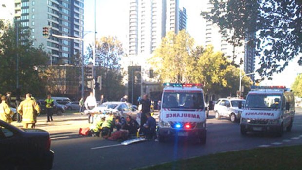 Pedestrian collision ... ambulance crews treat a man who was hit by a car on City Road.