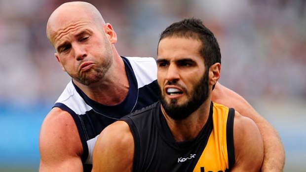 Bachar Houli, being tackled here by Geelong's Paul Chapman, has been enjoying another consistent season across half-back with a hardened defensive edge.