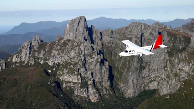 Untamed beauty: the Par Avion plane passes the South West Wilderness's dramatic rock faces.