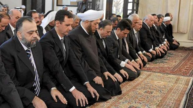 In this image supplied by Syria's state news agency SANA,  President Bashar al-Assad (second from left) prays during celebrations of the Prophet Muhammad's birthday at the al-Afram mosque in Damascus.