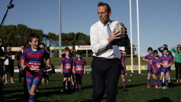 Home game: Opposition Leader Tony Abbott with under-9 Manly Christian Brothers players during a visit to Brookvale Oval in August.