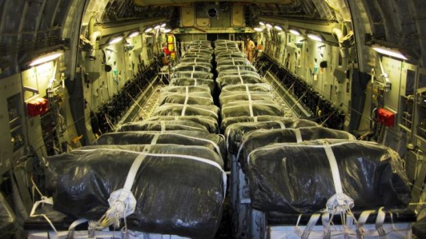 Pallets of bottled water aboard a US Air Force C-17 Globemaster III aircraft in preparation for a humanitarian airdrop over Iraq.