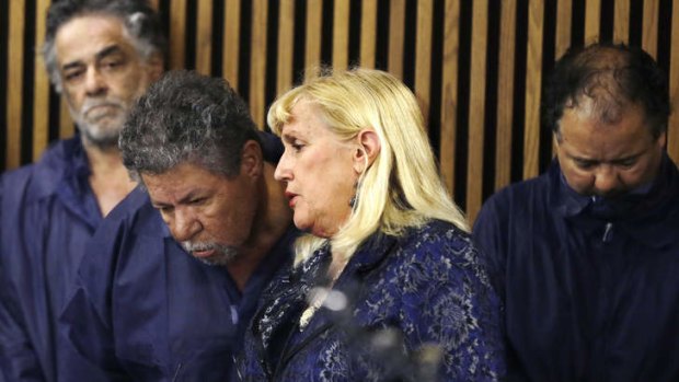 In court: Lawyer Kathleen DeMetz talks with Pedro Castro as Onil Castro, left,  watches and Ariel Castro, right, looks down.