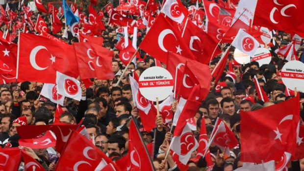 Supporters of the Nationalist Movement Party wave national and party flags in Ankara.