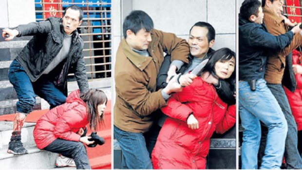 Chinese police overwhelm and disarm a man who was holding a woman hostage at knifepoint during an attempted robbery in Wuxi, in eastern China.