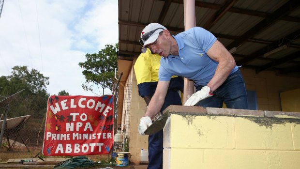 Prime Minister Tony Abbott assists in the community hall upgrade in the Injinoo community, Cape York. 