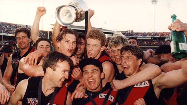 James Hird (fourth from right) and Mark Thompson, right celebrate winning the 1993 grand final with Essendon.