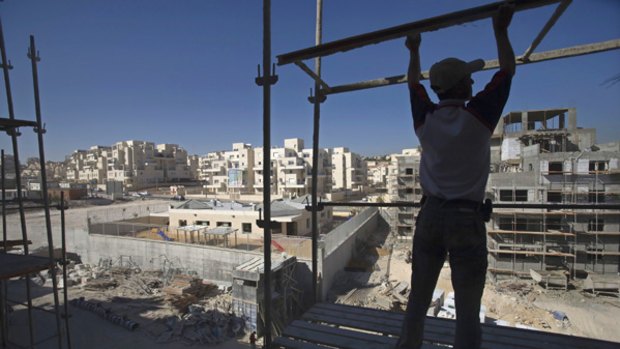 A Palestinian labourer works at a construction site in the West Bank Jewish settlement of Maale Adumim.