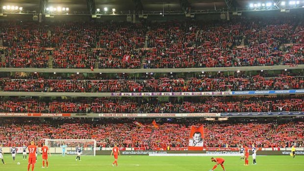 The crowd of 95,446 sing You'll Never Walk Alone during the match between the Melbourne Victory and Liverpool at the Melbourne Cricket Ground.