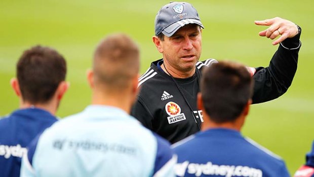 Sydney FC coach Frank Farina speaks to his players during a training session at Macquarie Uni on Tuesday.