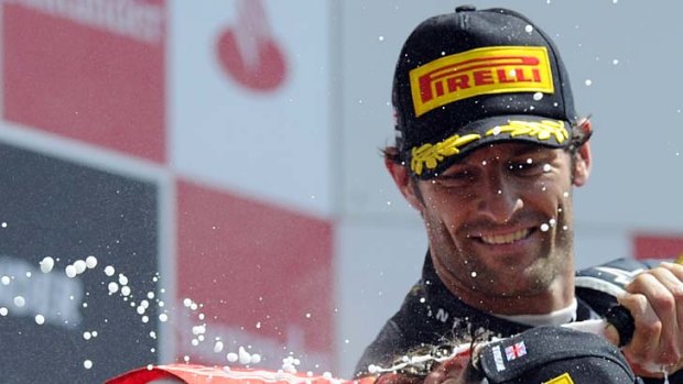 Mark Webber sprays Fernando Alonso after the Spaniard won the British Grand Prix.