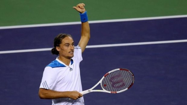 Big scalp: Alexandr Dolgopolov waves to the crowd after beating Rafael Nadal at Indian Wells.
