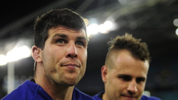 In doubt: Michael Ennis watches on from the bench after being hurt playing the Panthers.