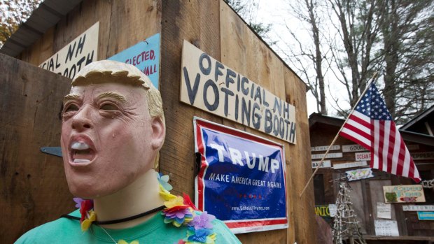 A mannequin for Republican presidential candidate Donald Trump is on display outside an outhouse used as an unofficial voting booth on a farm in New Hampshire.